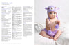 A baby sits on a soft white blanket wearing a purple animal hat with ear flaps and pom-poms, matching diaper cover. Text on left with knitting instructions.