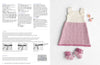 A knitted baby dress with pink and white stripes is displayed on a textured background, alongside matching booties and two pink daisies. Instructions and patterns appear on the left. The tone is soft and cozy.