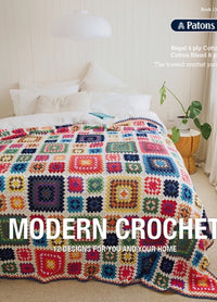 A cozy bed with colorful, geometric-patterned crochet blanket in a bright, minimalist bedroom. Text reads "Modern Crochet: 12 Designs for You and Your Home."