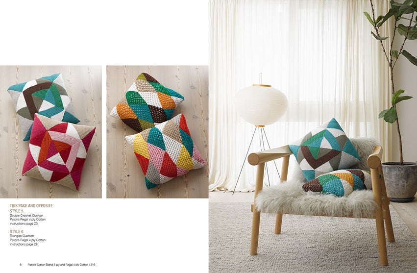 Colorful geometric cushions on a wooden floor, paired with a cozy chair. Natural light and a potted plant enhance the room's serene vibe.