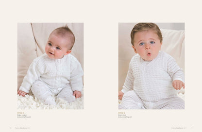 Two babies in white knitted outfits sit on a soft surface. The left baby smiles gently, while the right baby looks surprised. The atmosphere is cozy and warm.