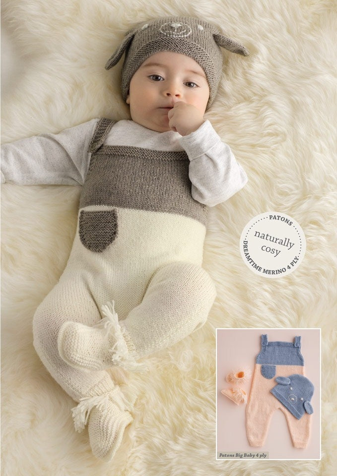 A baby in a cozy, woolen outfit with a gray hat featuring floppy ears, lying on a soft cream-colored rug. A small inset shows a blue and peach version of the outfit.