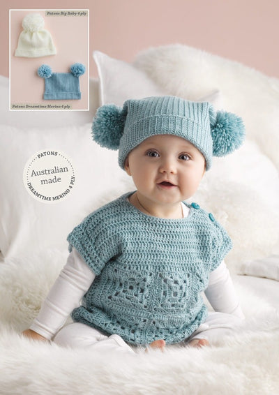 A baby wearing a blue crocheted top and pom-pom hat sits on a fluffy white blanket. Inset shows two hats: cream and blue. Tone: cozy, cheerful.