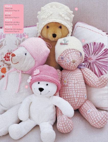 Four cuddly teddy bears sit on a sofa, each with a unique hat. The scene is cozy and playful, with soft colors such as pink, cream, and beige.