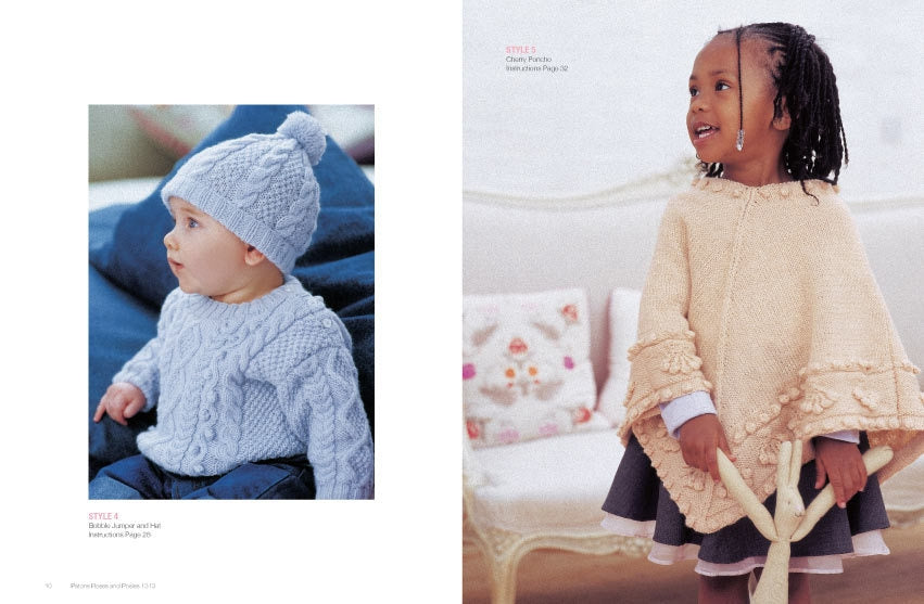 A baby in a blue knit sweater and hat sits on the left, while a smiling young girl in a beige poncho holds a toy on the right, conveying warmth and coziness.