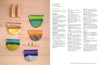 Five colorful crocheted purses arranged vertically on a wooden surface. A blurred text page on the right provides intermediate crochet instructions.