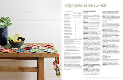 A wooden table displays a colorful crocheted motif runner with geometric patterns, topped with a black bowl of lemons and a potted plant. White wall backdrop and text on the right. Cozy and inviting atmosphere.