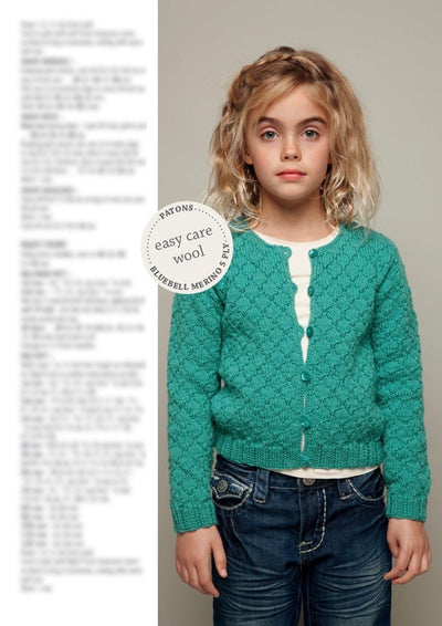 A young girl with curly blonde hair wears a textured teal cardigan over a white shirt and jeans. The background text is blurred. The mood is serene.
