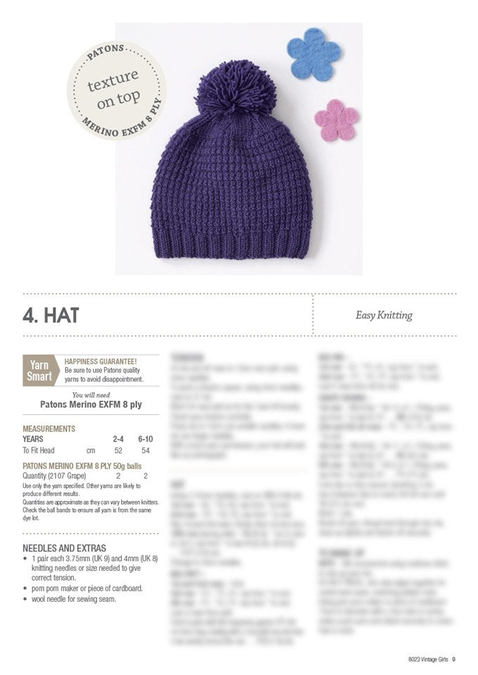 Purple knitted hat with pom-pom atop, accompanied by blue and pink felt flowers. Text indicates easy knitting pattern instructions below.