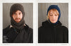 Split image of a man and a woman wearing knitted headgear. The man on the left wears a brown balaclava with a coat, looking forward. The woman on the right wears a blue knit hood with a black jacket, eyes closed and smiling slightly. Cozy, warm winter fashion.