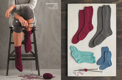 A person sitting on a ladder is knitting burgundy socks, with yarn and needles nearby. On the right, burgundy, gray, teal, and blue socks are displayed on a board.
