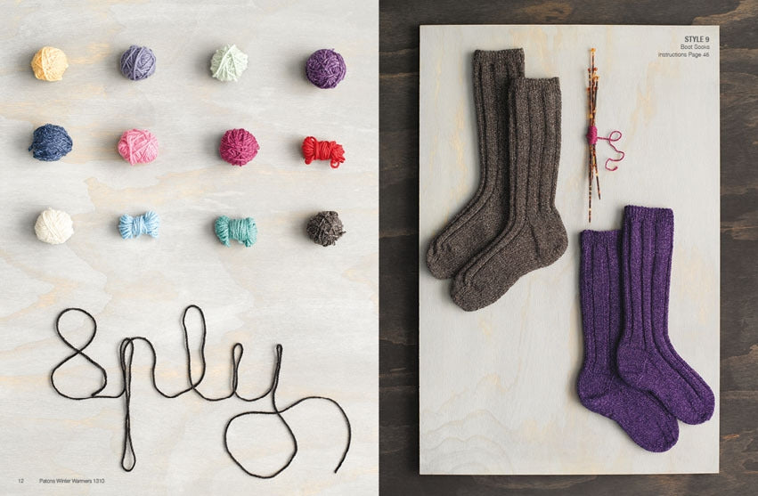 Colourful yarn balls arranged next to knitted brown and purple socks on wood. Yarn spelled as "sply." Cozy, crafty, and inviting atmosphere.