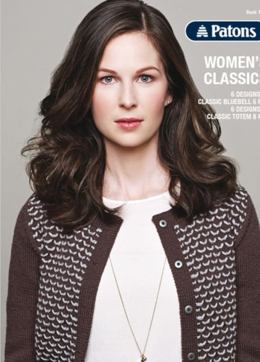 A woman with long, wavy brown hair wears a patterned brown and white cardigan over a white top. She has a calm expression, set against a gray background.
