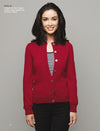 Smiling woman wearing a red buttoned cardigan over a black-and-white striped top stands against a gray background, conveying a casual, cheerful tone.