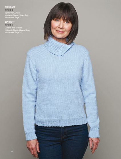 A woman in a light blue sweater and jeans stands against a gray background. She smiles softly, exuding a warm and cozy mood.