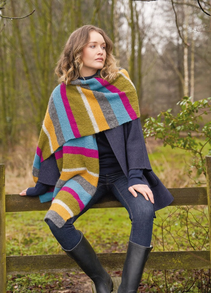 Generous, softly draping wrap striped in six shades of Alpaca Classic, balancing texture and colour for warmth and style.