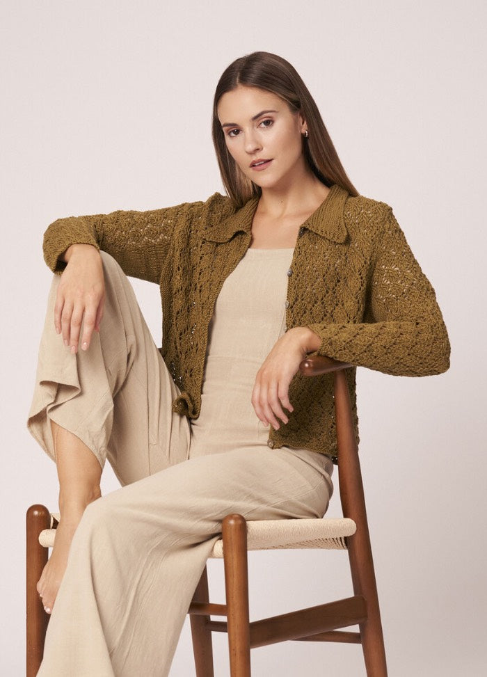 Lightweight knitted pullover with subtle texture, worn casually with summer trousers.