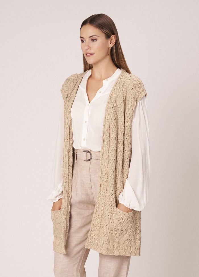 Classic cotton pullover with subtle cable detailing, worn with neutral accessories.