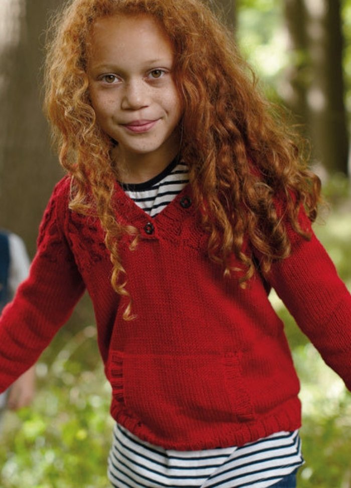 Child in red Pilot Sweater with V-neck, buttons, and pocket, over striped shirt, outdoors.