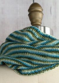 Pirouette Cowl on mannequin, hand-knit in soft blue and green stripes with a smooth, cozy texture.