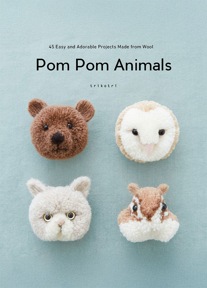 Cover of Pom Pom Animals: 45 Easy and Adorable Projects Made from Wool, showing five fuzzy animal faces made from pom-poms—including a bear, an owl, a rabbit, a fox, and a cat—arranged against a soft pale-blue background with the title centered above in simple black text.