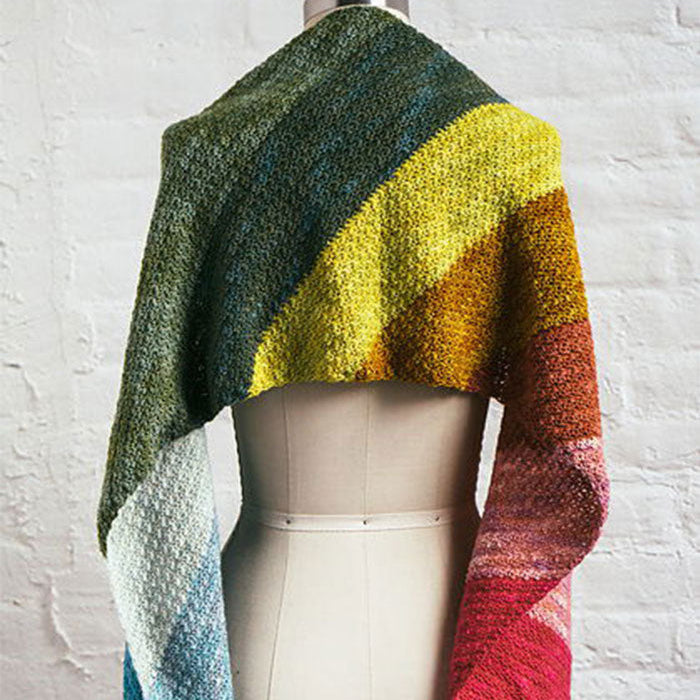Rainbow Showers Scarf on mannequin, hand-knit with a soft gradient of green, yellow, orange, red, pink, and blue.