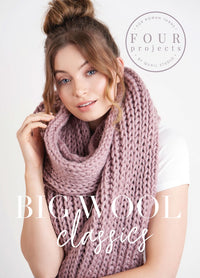 A woman with a top bun wears a chunky, soft pink knitted scarf. The look is cozy and stylish. Text: “Big Wool Classics” and “Four Projects.”