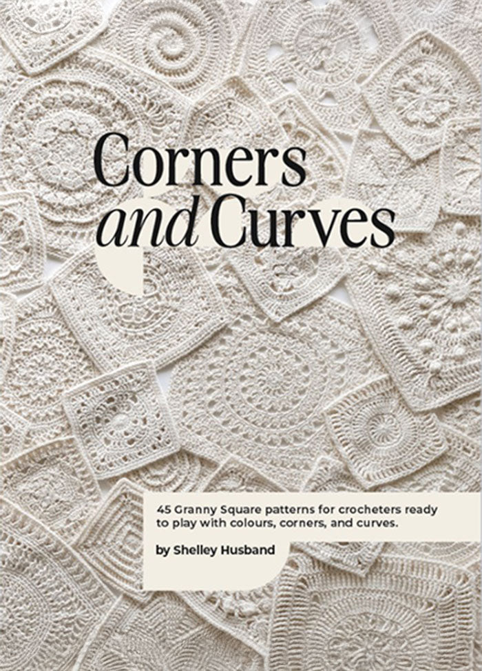 A textured cover featuring various intricately crocheted granny squares in white. The title "Corners and Curves" overlays the pattern, conveying a sense of craftsmanship.