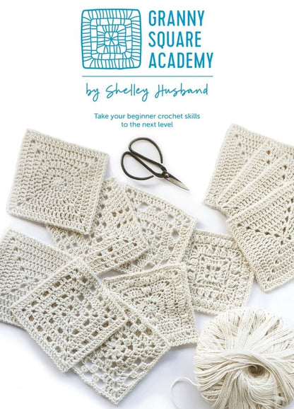 Granny Square Academy” logo above various crocheted squares, yarn, and scissors on a white background, conveying a serene, creative vibe.