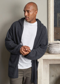 A man wearing a white t-shirt under a soft, textured gray cardigan with a relaxed fit and open front.