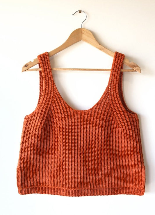 Orange ribbed knit tank top on a wooden hanger against a plain white background. The textured fabric emphasizes a casual and cozy vibe.