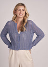Model in a relaxed-fit cotton sweater with ribbed detailing and rolled sleeves.