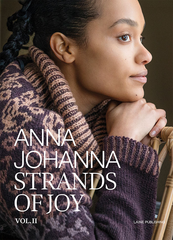 Strands of Joy Vol. II: front cover featuring a patterned knit sweater by Anna Johanna, published by Laine.