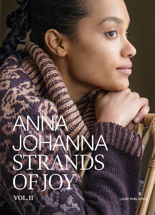 Strands of Joy Vol. II: front cover featuring a patterned knit sweater by Anna Johanna, published by Laine.