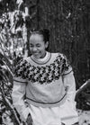Bubbles and Giggles Sweater: light-colored knit with dark circular bubble motifs on upper section, worn over a white shirt in snowy outdoor setting.