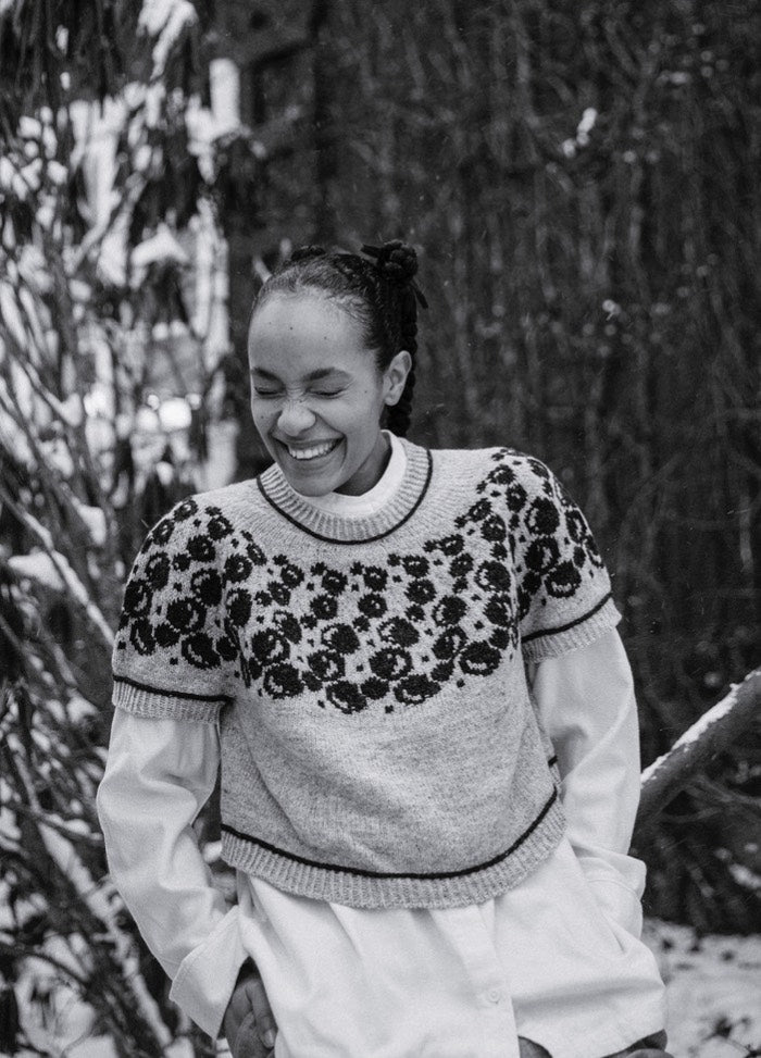 Bubbles and Giggles Sweater: light-colored knit with dark circular bubble motifs on upper section, worn over a white shirt in snowy outdoor setting.