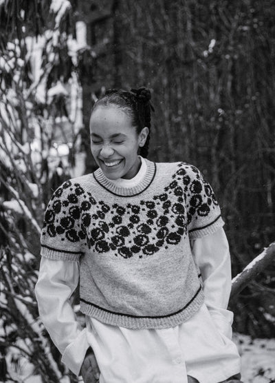 Bubbles and Giggles Sweater: light-colored knit with dark circular bubble motifs on upper section, worn over a white shirt in snowy outdoor setting.