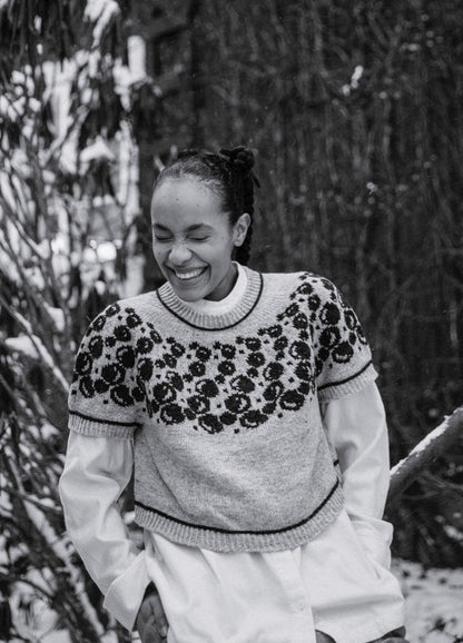 Bubbles and Giggles Sweater: light-colored knit with dark circular bubble motifs on upper section, worn over a white shirt in snowy outdoor setting.