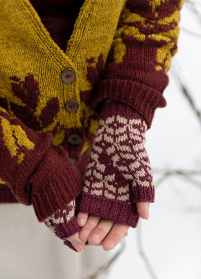Scented Erasers Mittens: maroon and white fingerless mittens paired with a yellow and maroon patterned cardigan.
