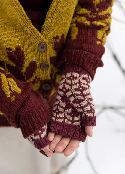 Scented Erasers Mittens: maroon and white fingerless mittens paired with a yellow and maroon patterned cardigan.