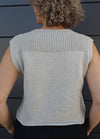Lightweight knitted Summer Esio Top in a sleeveless design, featuring ribbed edges and a clean silhouette. Ideal for warm-weather outfits, styled with dark trousers for a modern casual look.