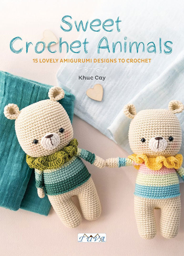 Cover of Sweet Crochet Animals by Khuc Cay, showing two crocheted bear dolls holding hands, dressed in striped sweaters with ruffled collars, lying on soft teal and white fabric.