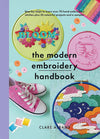 Cover of The Modern Embroidery Handbook by Clare Albans, featuring a vibrant collage of embroidery hoops displaying colorful floral and whimsical designs, including a 'BLOOM' motif, a rainbow, and a moonlit sky. The title is prominently displayed in bold black letters against a mint-green background.