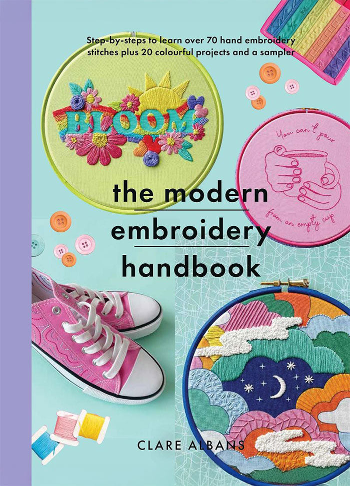 Cover of The Modern Embroidery Handbook by Clare Albans, featuring a vibrant collage of embroidery hoops displaying colorful floral and whimsical designs, including a 'BLOOM' motif, a rainbow, and a moonlit sky. The title is prominently displayed in bold black letters against a mint-green background.