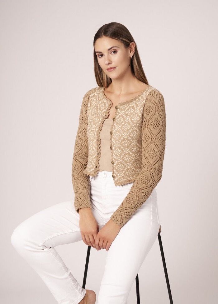 Knitted tunic with side slits and airy construction, styled for casual summer wear.