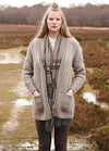 Person wearing the Welsh Cardigan, a long textured grey cardigan with pockets.