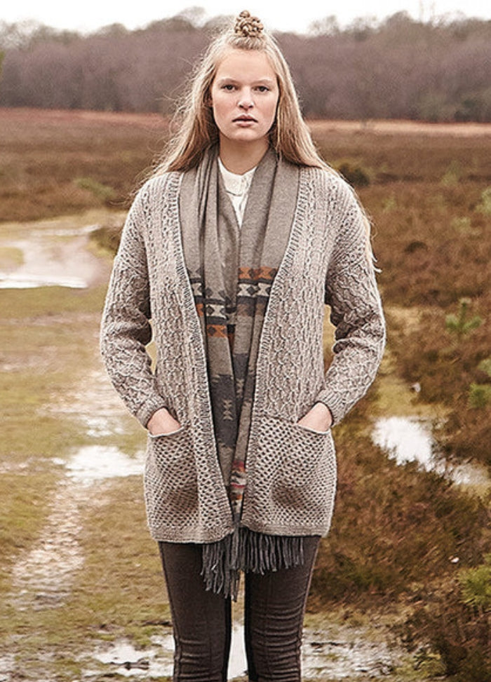 Person wearing the Welsh Cardigan, a long textured grey cardigan with pockets.