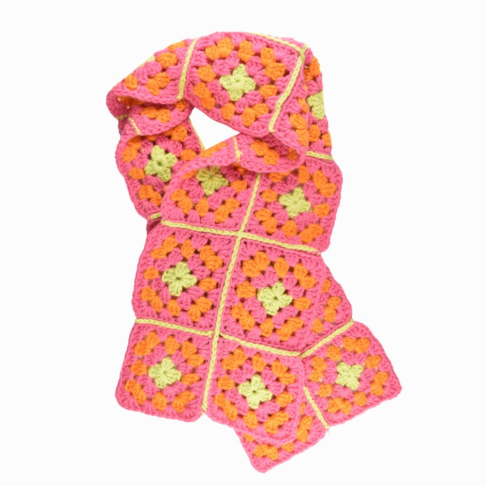 A crocheted scarf featuring a vibrant pink and green design, showcasing intricate patterns and textures.
